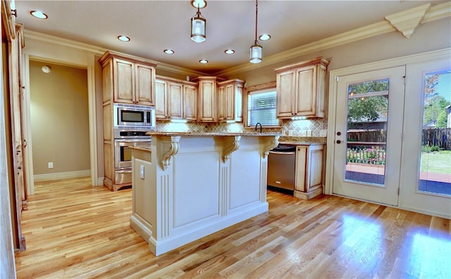 kitchen with stainless steel appliances, light stone counters, a breakfast bar area, crown molding, and light wood-style floors