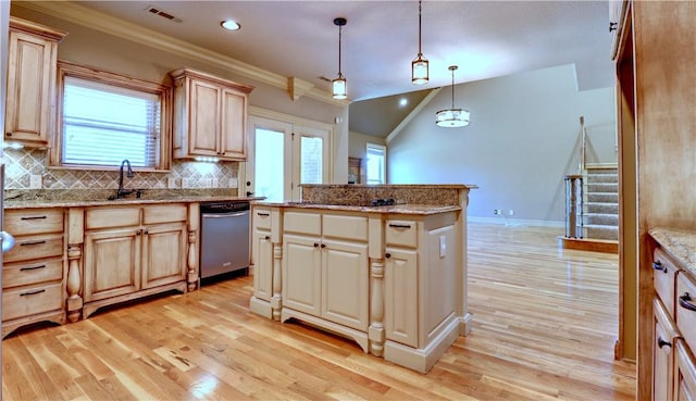 kitchen with a sink, stainless steel dishwasher, decorative backsplash, and light wood-style floors