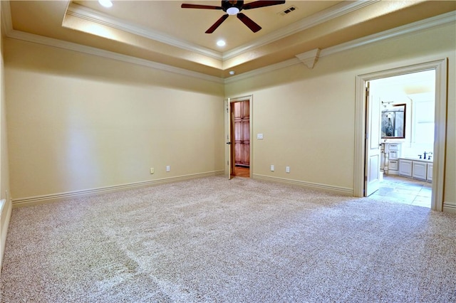 unfurnished room with carpet, a tray ceiling, ceiling fan, ornamental molding, and recessed lighting