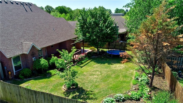 view of yard with a fenced backyard and a trampoline