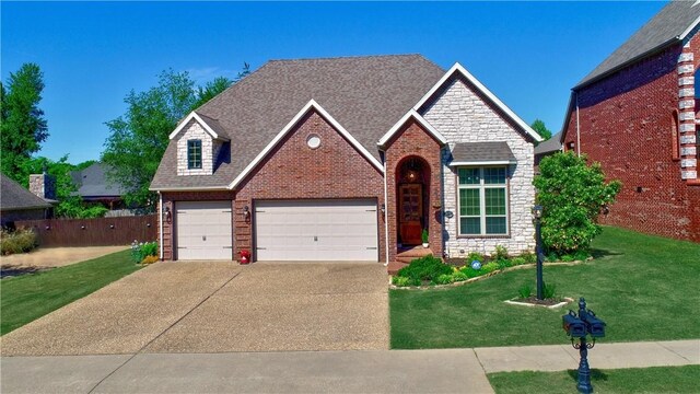 view of front of home featuring driveway, brick siding, a front lawn, and a garage
