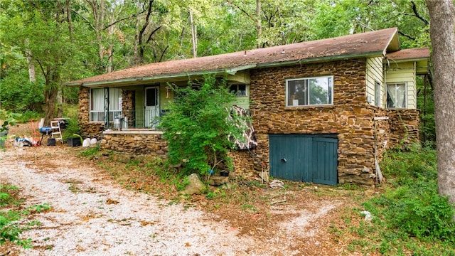 view of front of house featuring stone siding and covered porch