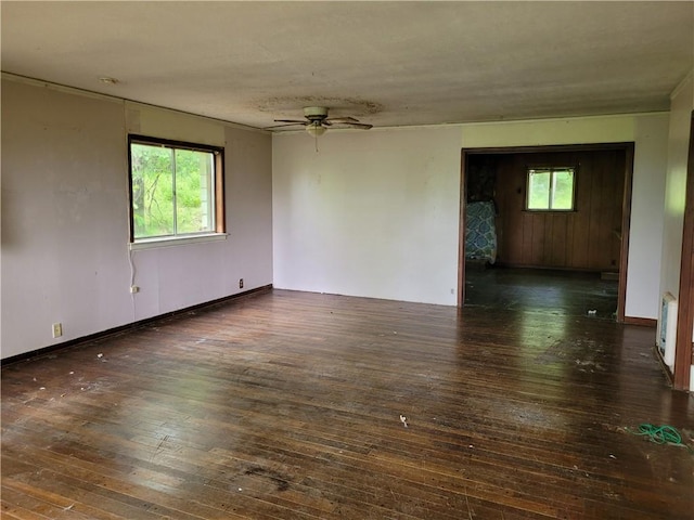 unfurnished room with hardwood / wood-style flooring, a ceiling fan, and plenty of natural light