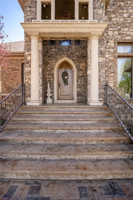 doorway to property featuring stone siding