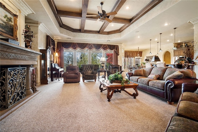 carpeted living room with a fireplace with raised hearth, coffered ceiling, ceiling fan, crown molding, and beamed ceiling