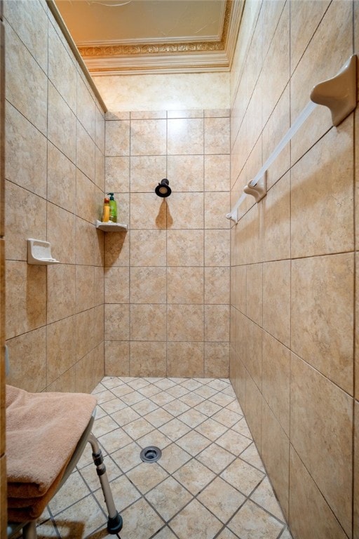 bathroom with tiled shower and ornamental molding