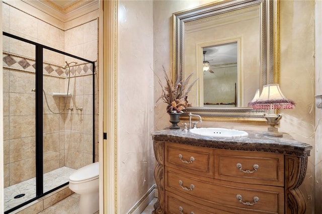 bathroom featuring a stall shower, toilet, ornamental molding, ceiling fan, and vanity