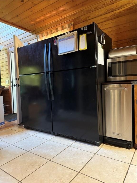 2132 County Road 246, Berryville, AR 72616 - kitchen with freestanding refrigerator, wooden ceiling, light tile patterned floors, stainless steel microwave, and wood walls