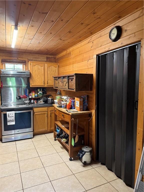 2132 County Road 246, Berryville, AR 72616 - kitchen with dark countertops, wood ceiling, light tile patterned floors, and stainless steel range with electric cooktop