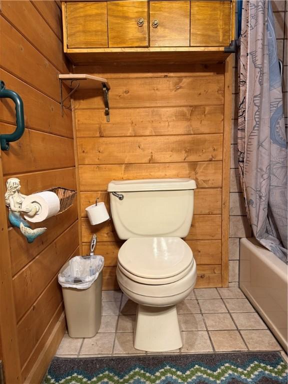 2132 County Road 246, Berryville, AR 72616 - full bathroom featuring shower / tub combo with curtain, tile patterned flooring, toilet, and wooden walls
