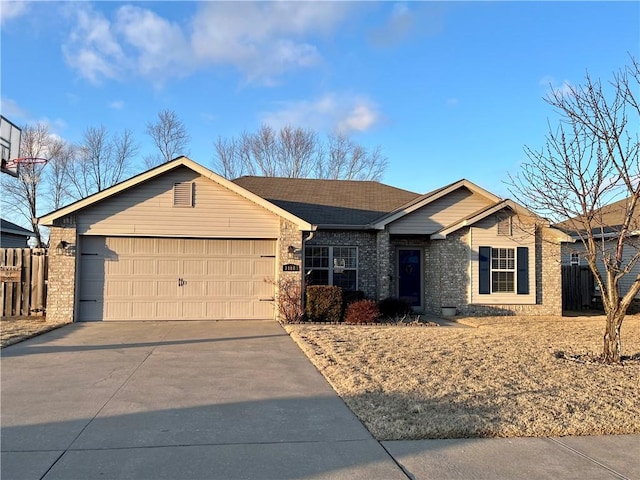 ranch-style house with an attached garage, concrete driveway, brick siding, and fence