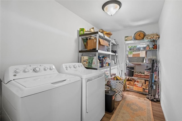 101 Carter Ln, Elkins, AR 72727 - washroom featuring separate washer and dryer, laundry area, and wood finished floors