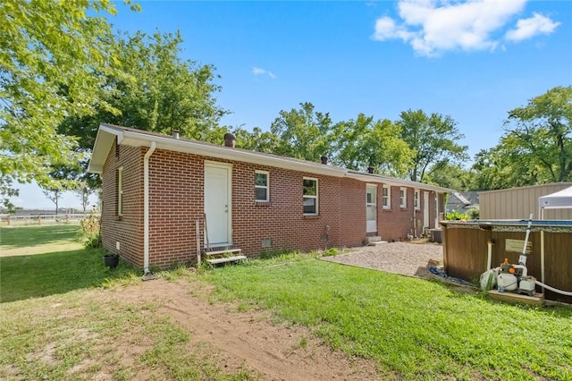 101 Carter Ln, Elkins, AR 72727 - rear view of property featuring a yard, entry steps, brick siding, and crawl space