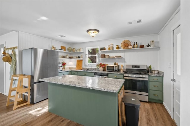 101 Carter Ln, Elkins, AR 72727 - kitchen with a sink, open shelves, appliances with stainless steel finishes, green cabinets, and light wood-style floors