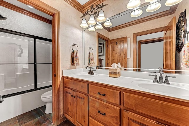 full bath featuring toilet, ornamental molding, double vanity, and a sink