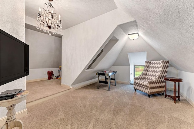 interior space with vaulted ceiling, a textured ceiling, carpet, and baseboards