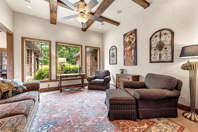 living area featuring baseboards, beamed ceiling, recessed lighting, and ceiling fan