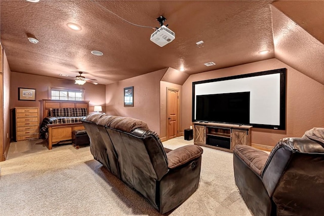 cinema with light carpet, a textured ceiling, a ceiling fan, and visible vents