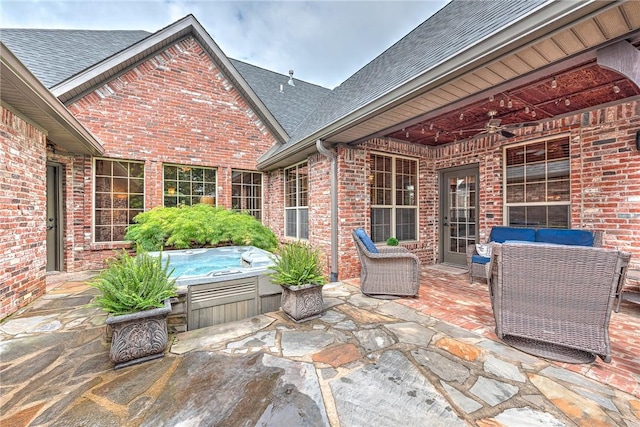 view of patio / terrace with a hot tub and a ceiling fan