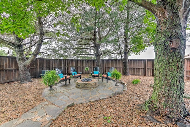 view of patio featuring a fenced backyard and a fire pit