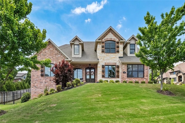view of front of house featuring brick siding, stone siding, and a shingled roof