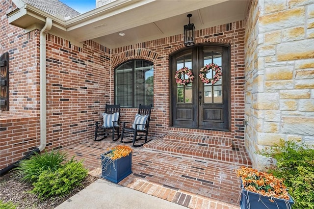 entrance to property with brick siding and french doors