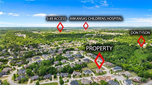 aerial view of property and surrounding area featuring nearby suburban area