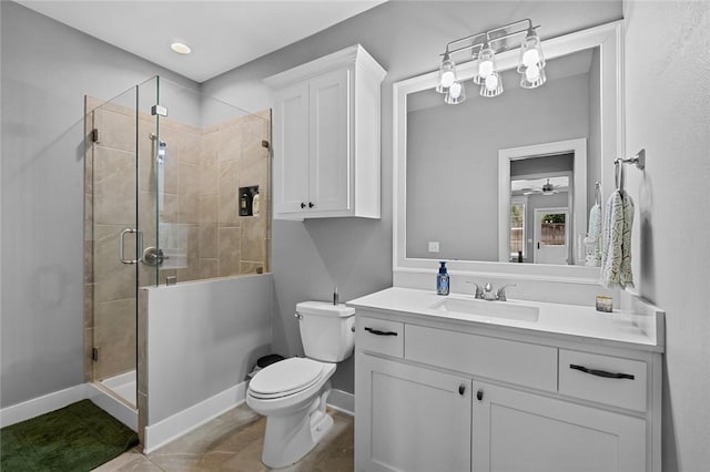 full bathroom featuring baseboards, toilet, a shower stall, vanity, and tile patterned floors