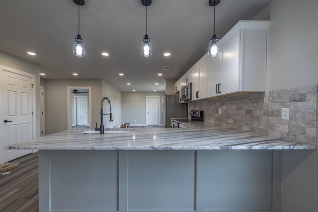 190 Madison Unit 6124, Elkins, AR 72727 - kitchen with a sink, stainless steel appliances, light stone counters, white cabinetry, and recessed lighting