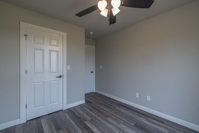 190 Madison Unit 6124, Elkins, AR 72727 - unfurnished bedroom with dark wood finished floors, baseboards, and ceiling fan
