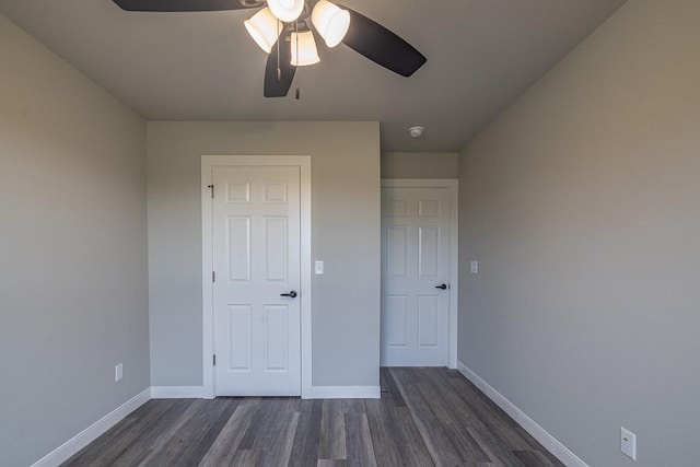 190 Madison Unit 6124, Elkins, AR 72727 - unfurnished bedroom with dark wood finished floors, baseboards, and ceiling fan