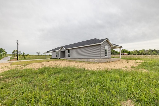 190 Madison Unit 6124, Elkins, AR 72727 - view of side of home with driveway and a carport