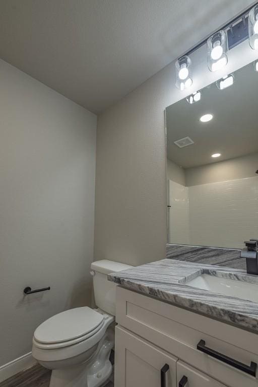 190 Madison Unit 6124, Elkins, AR 72727 - bathroom featuring vanity, toilet, wood finished floors, and baseboards