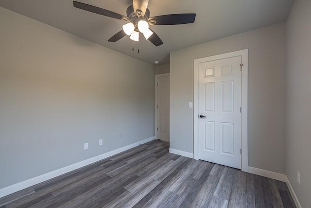 190 Madison Unit 6124, Elkins, AR 72727 - spare room featuring dark wood-type flooring, a ceiling fan, and baseboards