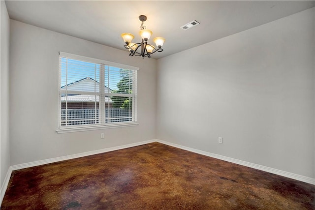 empty room featuring a chandelier, finished concrete flooring, and baseboards