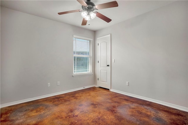 unfurnished room with concrete floors, baseboards, and a ceiling fan