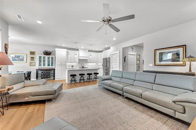 2227 Riggins Ave, Pea Ridge, AR 72751 - living area featuring light wood-type flooring, ceiling fan, and recessed lighting