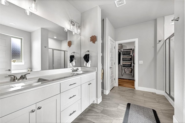 2227 Riggins Ave, Pea Ridge, AR 72751 - bathroom with a stall shower, a walk in closet, double vanity, and baseboards