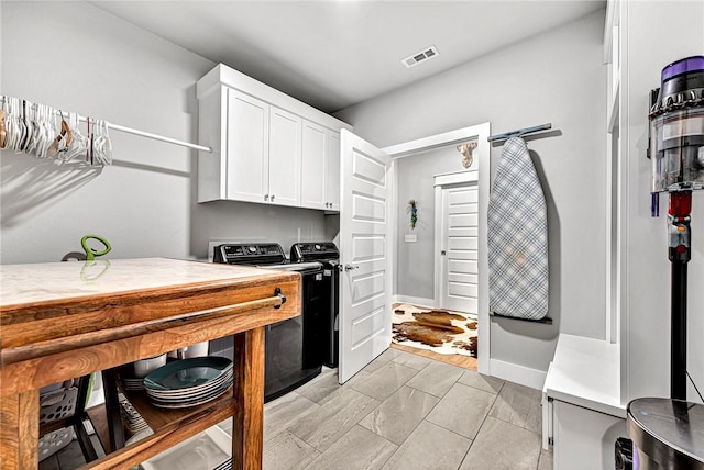 2227 Riggins Ave, Pea Ridge, AR 72751 - kitchen featuring independent washer and dryer, white cabinets, light countertops, and baseboards