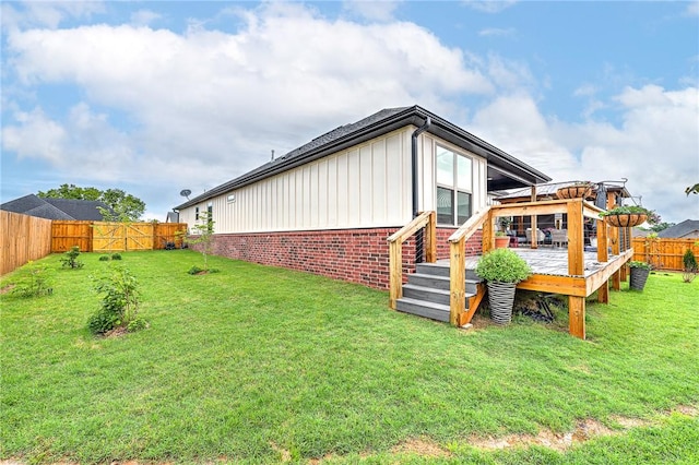 2227 Riggins Ave, Pea Ridge, AR 72751 - back of property featuring board and batten siding, a deck, and brick siding