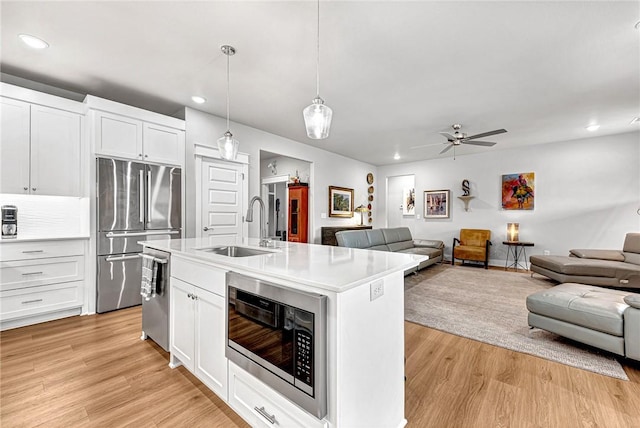 2227 Riggins Ave, Pea Ridge, AR 72751 - kitchen featuring a sink, stainless steel appliances, open floor plan, recessed lighting, and a ceiling fan