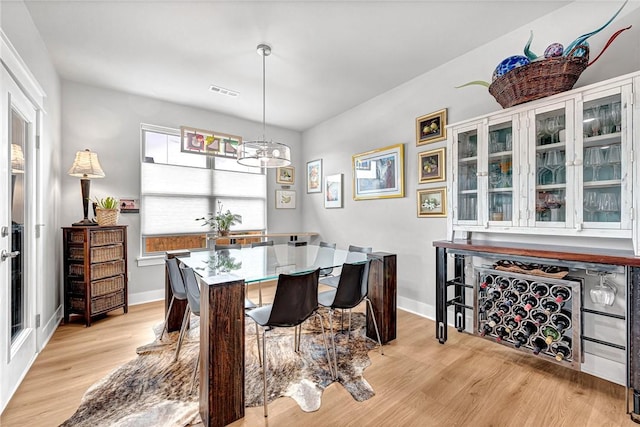 2227 Riggins Ave, Pea Ridge, AR 72751 - dining space featuring light wood finished floors, a chandelier, and baseboards