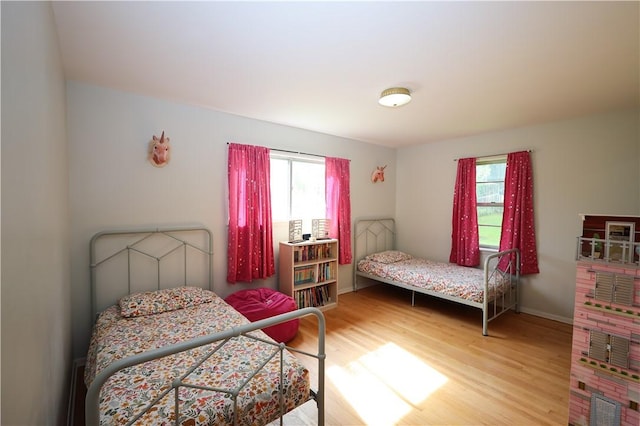 910 Sunset Ln, Harrison, AR 72601 - bedroom with multiple windows, wood finished floors, and baseboards