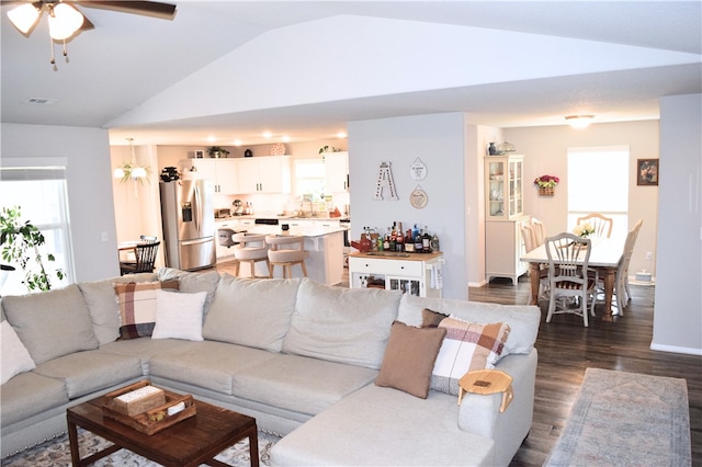 living area with vaulted ceiling, dark wood finished floors, and a ceiling fan