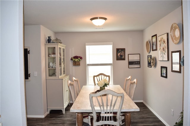 dining area featuring dark wood-style floors and baseboards