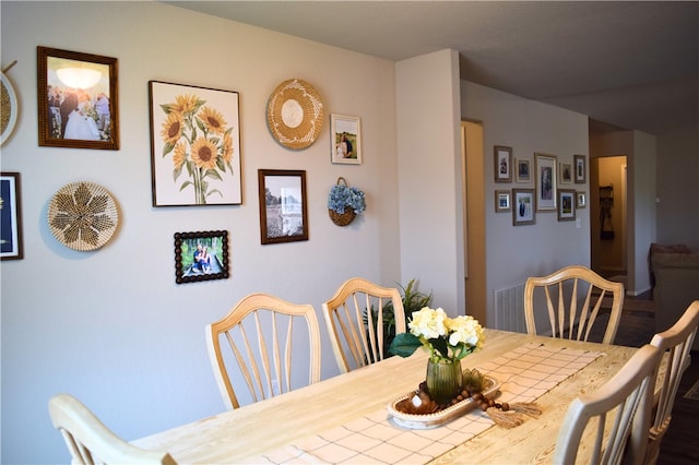 dining area with wood finished floors