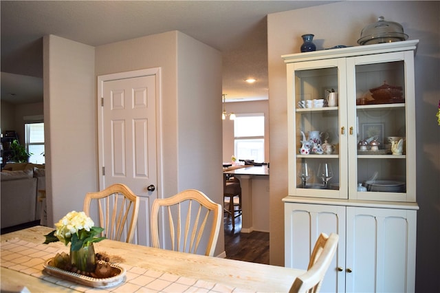 dining space with wood finished floors, healthy amount of natural light, and recessed lighting