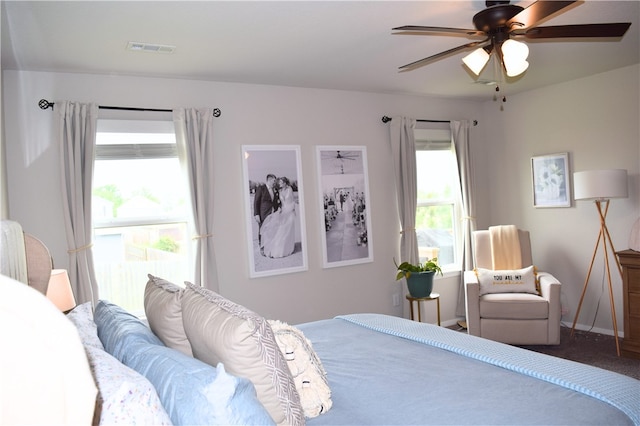 bedroom with baseboards, a ceiling fan, and carpet flooring
