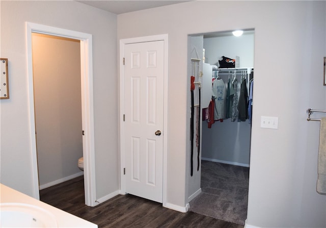 bathroom featuring wood finished floors, a sink, baseboards, and toilet