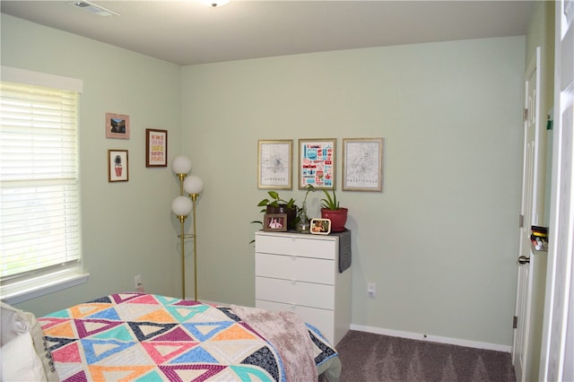 bedroom with carpet floors and baseboards